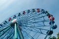 Colorful ride ferris wheel in motion in amusement park on sky background Royalty Free Stock Photo