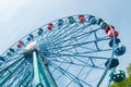 Colorful ride ferris wheel in motion in amusement park on sky background Royalty Free Stock Photo