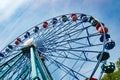 Colorful ride ferris wheel in motion in amusement park on sky background Royalty Free Stock Photo