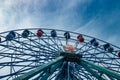 Colorful ride ferris wheel in motion in amusement park on sky background Royalty Free Stock Photo