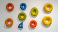 colorful donut shaped objects arranged on a white surface, creating a playful and modern art installation with vibrant hues and sm Royalty Free Stock Photo