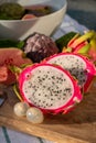 Colorful dragon fruit and peeled lychees, tasty tropical exotic fruits close up