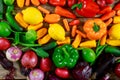 Red, green, yellow peppers, onion, eggplant on table