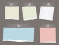 Colorful ripped, notebook, notepad paper sheets, note for text or message with stars on brown background.