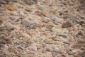 Colorful River Rocks In Sand Background