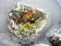 Colorful rock in a thermal mud pond