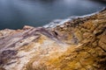 Colorful rocks by frozen reservoir Royalty Free Stock Photo