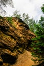 Colorful rocks next to the yellow and purple lake