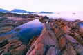 Colorful rocks and waves crashing on seashore Large colorful stones Royalty Free Stock Photo