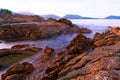 Colorful rocks and waves crashing on seashore Large colorful stones Royalty Free Stock Photo