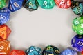 Colorful role playing RPG dice forming border around gray background