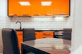 Small modern orange kitchen renovated in new apartment
