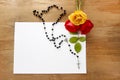 Colorful roses and black rosary