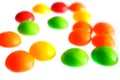 Colorful round candy pieces on white background