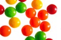 Colorful round candy pieces on white background