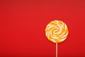 Colorful round Lollipop, on red background. Minimal concept with copy space Royalty Free Stock Photo