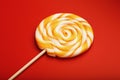 Colorful round Lollipop, on red background. Minimal concept with copy space Royalty Free Stock Photo