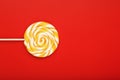 Colorful round Lollipop, on red background. Minimal concept with copy space Royalty Free Stock Photo