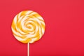 Colorful round Lollipop, on red background. Minimal concept with copy space Royalty Free Stock Photo