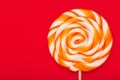 Colorful round Lollipop, on red background. Minimal concept with copy space Royalty Free Stock Photo