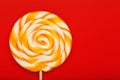 Colorful round Lollipop, on red background. Minimal concept with copy space Royalty Free Stock Photo