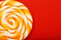 Colorful round Lollipop, on red background. Minimal concept with copy space Royalty Free Stock Photo