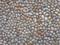 Colorful and round stones, stone wall texture, road made of small boulders and sea stones