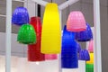 Colorful round stylish lampshades hang from ceiling