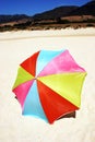 Colorful round umbrella on white sandy beach Royalty Free Stock Photo