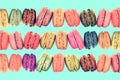 Colorful rows macarons on vintage pastel background