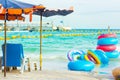 Colorful rubber rings and beach chairs at the beach. Royalty Free Stock Photo