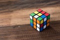 Colorful rubik`s cube on a wooden table background