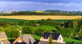 Colorful rural landscape with yellow bittercress fields