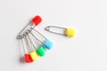 Colorful safety pins on white background, flat lay. Space for text Royalty Free Stock Photo