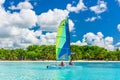 Colorful sail catamaran on the beach of Bayahibe at Caribbean Sea