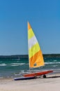 Colorful Sailboat on Trailer and Rubber Dinghy on Beach Ready for Action Royalty Free Stock Photo