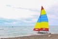 Colorful sailing boat on the beach on a cloudy day Royalty Free Stock Photo