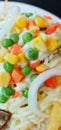 A colorful salad of carrots, green peas, corn and onions topped with a delicious sauce. Royalty Free Stock Photo