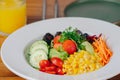 A colorful salad with a glass of orange juice on the side Royalty Free Stock Photo