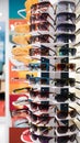 Colorful sales rack displays sunglasses for vibrant summer style Royalty Free Stock Photo