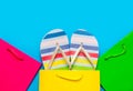 colorful sandals in cool shopping bag near other beautiful shopping bags on the wonderful blue background Royalty Free Stock Photo