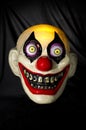 Colorful Scary Ugly Clown Mask on Dark Background