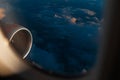 Colorful scenic view of beautiful sunset, cloudy sky and airplane engine, through window of the aircraft during the flight Royalty Free Stock Photo