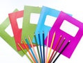 Colorful school exercise books and drawing pencils on white background Royalty Free Stock Photo