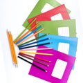 Colorful school exercise books and drawing pencils on white background Royalty Free Stock Photo