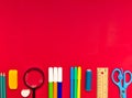 Colorful school suplies on red background