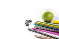 Colorful school supplies, book, apple on white. Close up. Back to school.