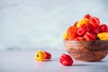 Colorful scotch bonnet chili peppers in wooden bowl over grey background. Copy space. Royalty Free Stock Photo