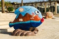 Colorful sculpture of fish with sea, mountains, sun, gulls painted on it, city museum, Eilat