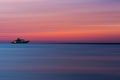 Colorful sea front view sunset with yacht at the horizon line, motion blur effect with clods and wave. Vacation time to relax and Royalty Free Stock Photo